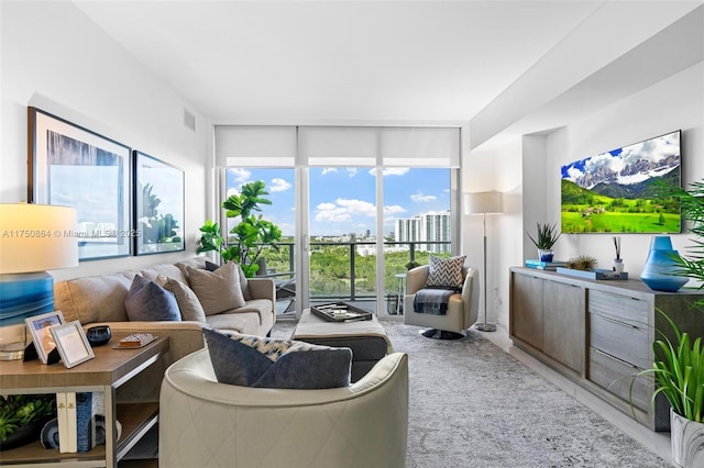 living area featuring visible vents and floor to ceiling windows