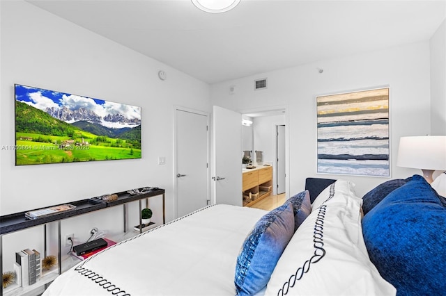 bedroom featuring visible vents and ensuite bathroom