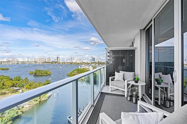 balcony featuring a view of city and a water view