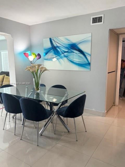 dining space with light tile patterned floors, baseboards, and visible vents