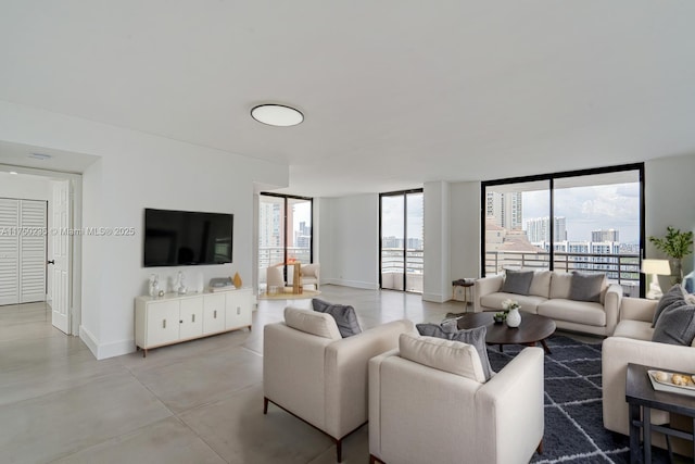 living area with concrete floors and baseboards