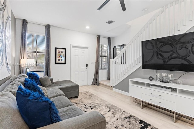 living room with light wood finished floors, visible vents, a ceiling fan, stairway, and recessed lighting