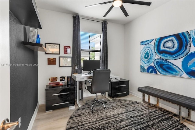 home office featuring ceiling fan, light wood-type flooring, and baseboards