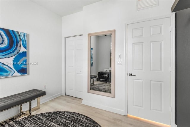 interior space with light wood-type flooring and baseboards