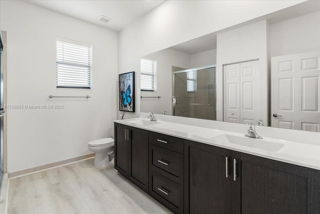 bathroom featuring double vanity, a closet, a sink, and visible vents