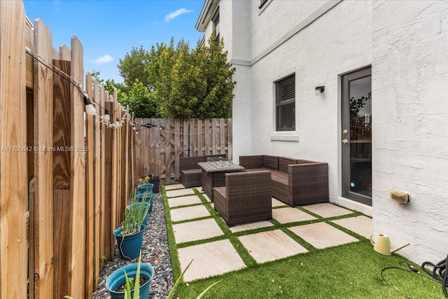 view of patio featuring a fenced backyard and an outdoor living space