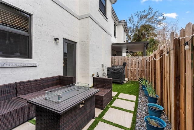 view of patio with a fenced backyard, an outdoor living space, and a ceiling fan