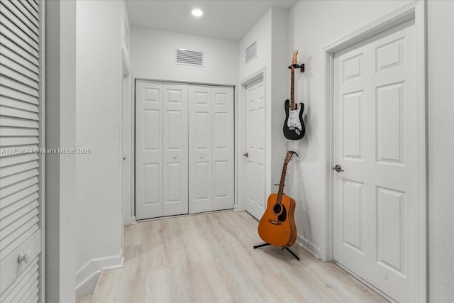 interior space featuring light wood-style flooring, recessed lighting, visible vents, and baseboards