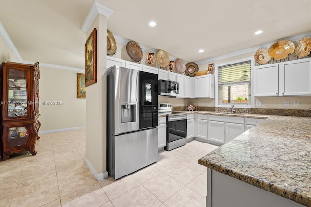 kitchen featuring crown molding, a sink, light tile patterned floors, and stainless steel appliances