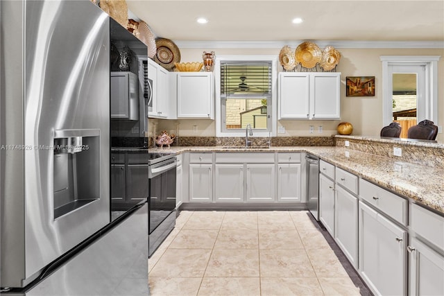 kitchen with white cabinets, stainless steel appliances, plenty of natural light, and a sink