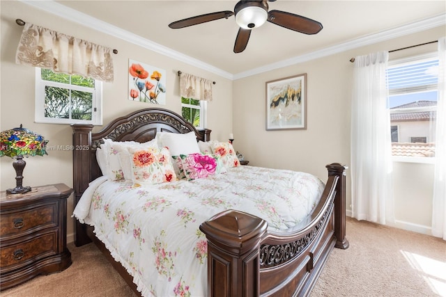 bedroom featuring crown molding, ceiling fan, and light colored carpet