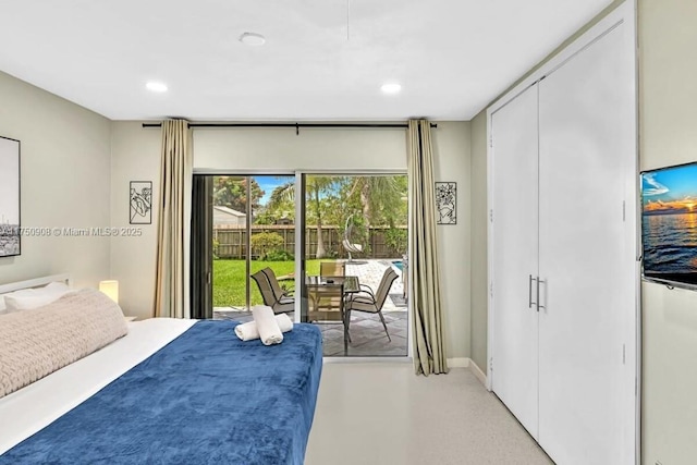 bedroom featuring access to outside, finished concrete floors, and recessed lighting