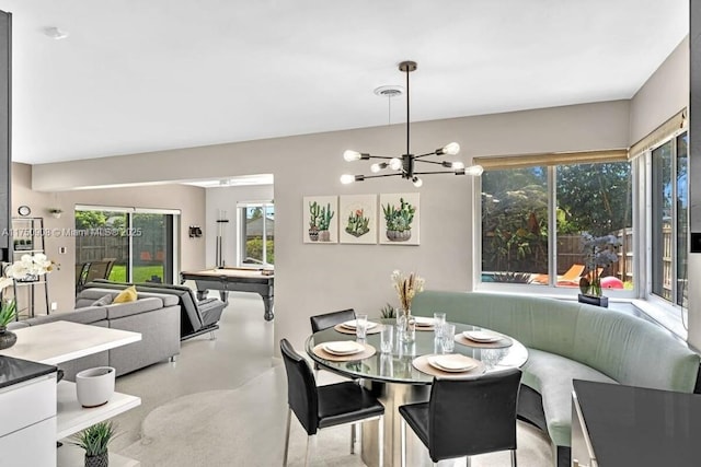 dining room with concrete floors, visible vents, and a chandelier