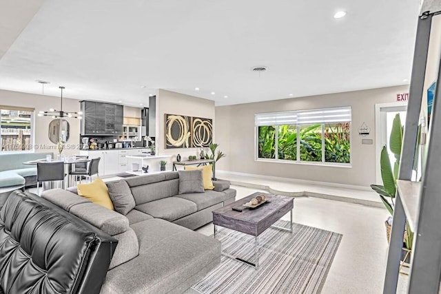 living room with visible vents, a wealth of natural light, and recessed lighting