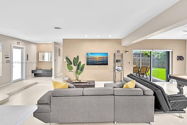 living room with baseboards, concrete floors, visible vents, and recessed lighting