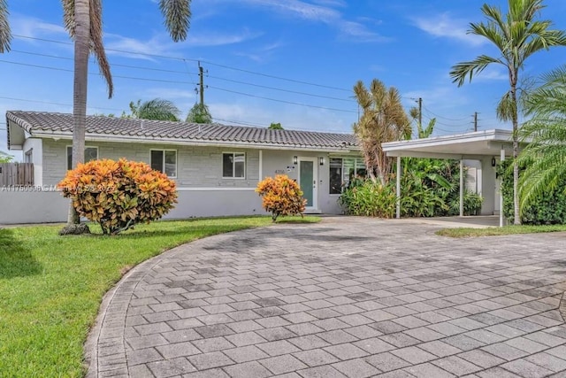 single story home with a tiled roof and a front yard