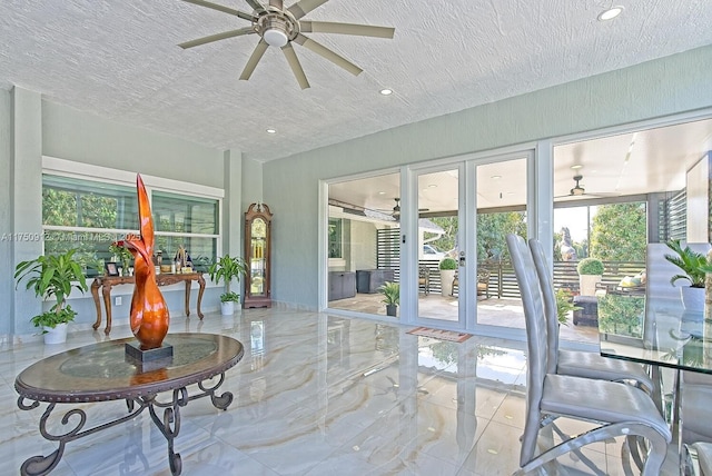 sunroom featuring a ceiling fan