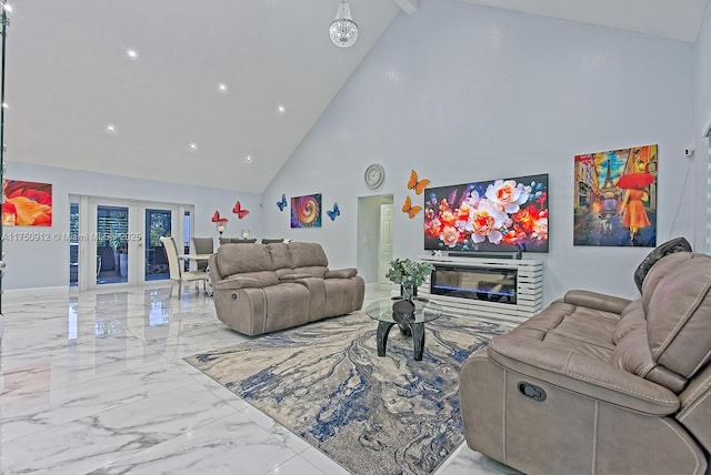 living area featuring marble finish floor, baseboards, a glass covered fireplace, and french doors