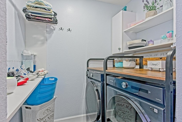 laundry room featuring cabinet space and washer and clothes dryer