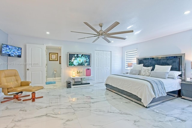 bedroom featuring a ceiling fan, ensuite bath, marble finish floor, a closet, and recessed lighting