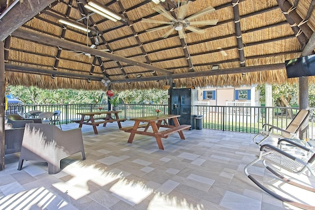 exterior space with ceiling fan, fence, and a gazebo