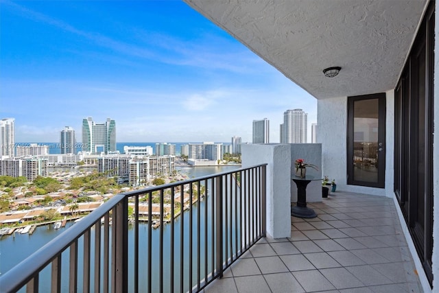 balcony featuring a view of city and a water view