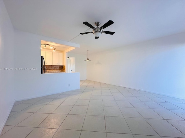 empty room featuring ceiling fan and light tile patterned flooring