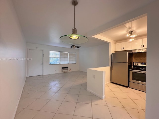 kitchen featuring stainless steel appliances, light countertops, white cabinetry, ceiling fan, and under cabinet range hood