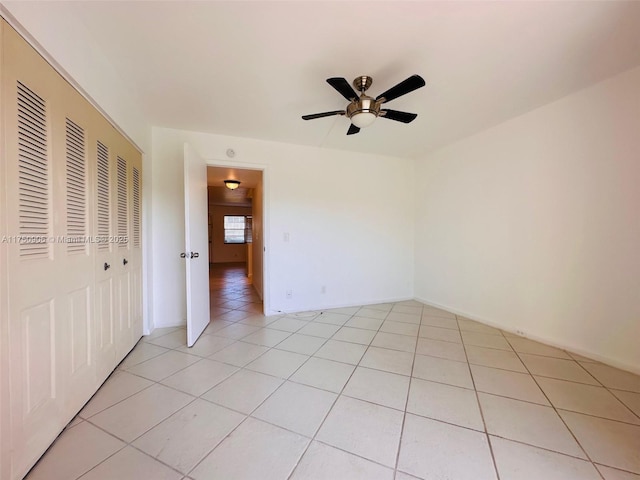 empty room featuring light tile patterned floors and a ceiling fan