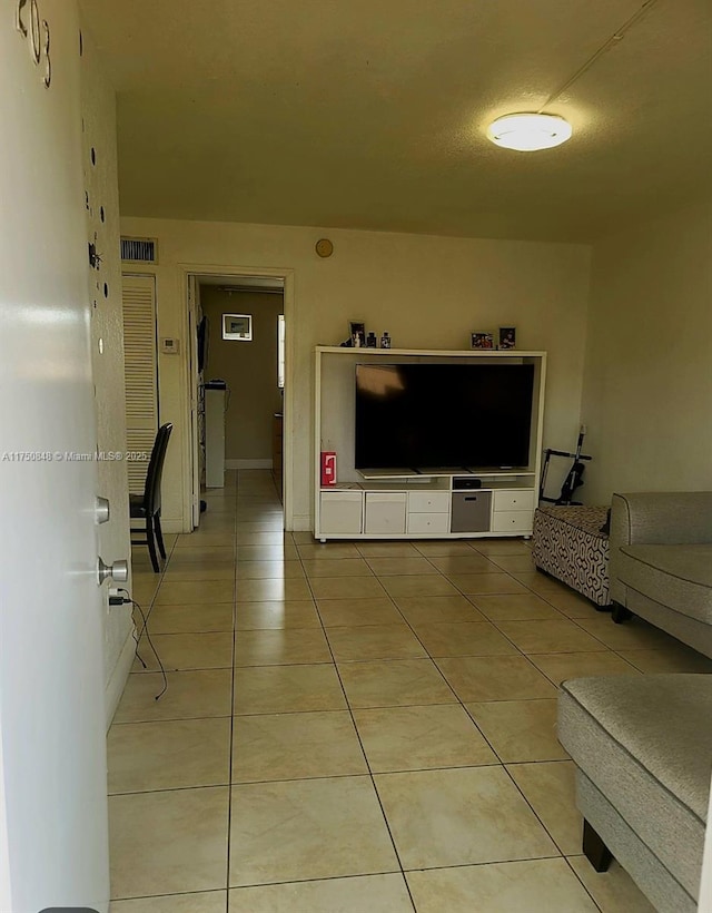 living room featuring visible vents and light tile patterned flooring