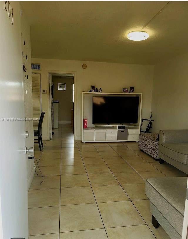 living room with light tile patterned flooring and visible vents