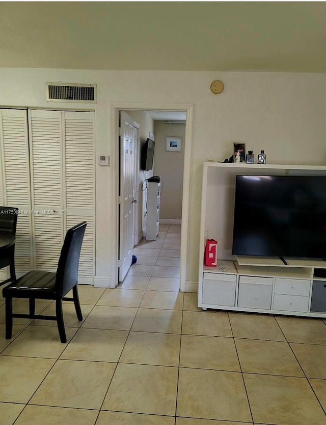 interior space with visible vents, baseboards, and light tile patterned floors