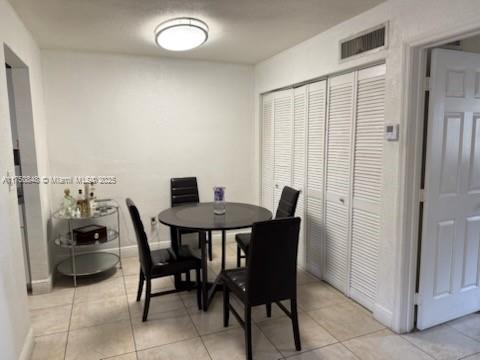 dining area with visible vents, baseboards, and light tile patterned floors