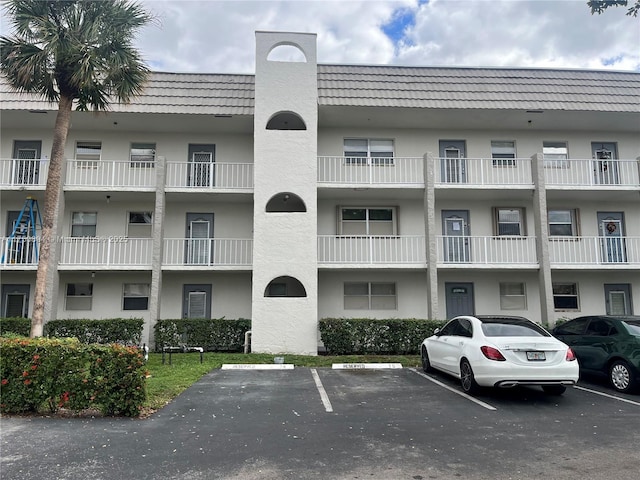 view of building exterior with uncovered parking