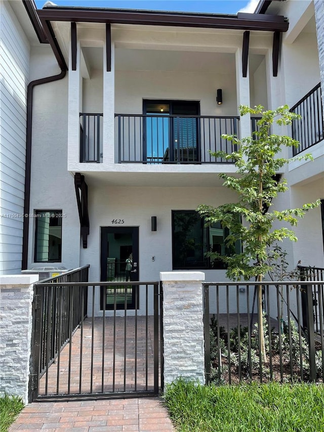 exterior space featuring a fenced front yard and stucco siding