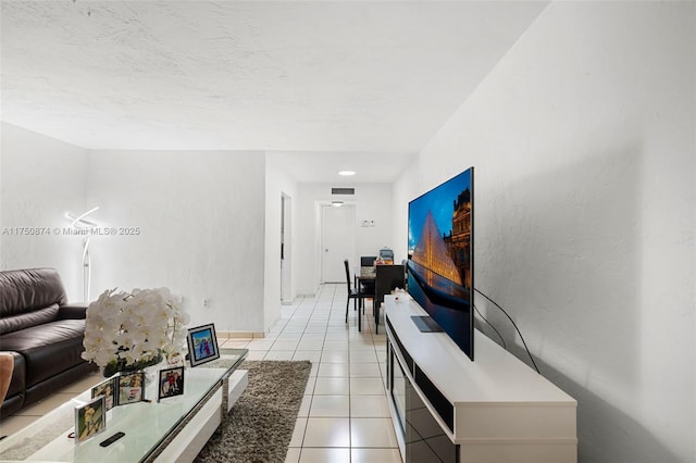 living room featuring light tile patterned flooring and visible vents