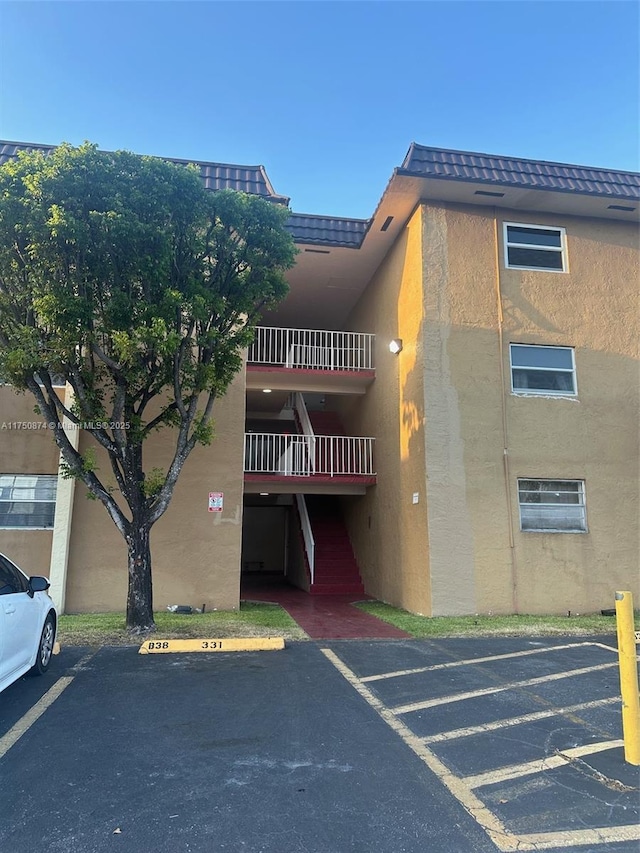 view of building exterior with uncovered parking