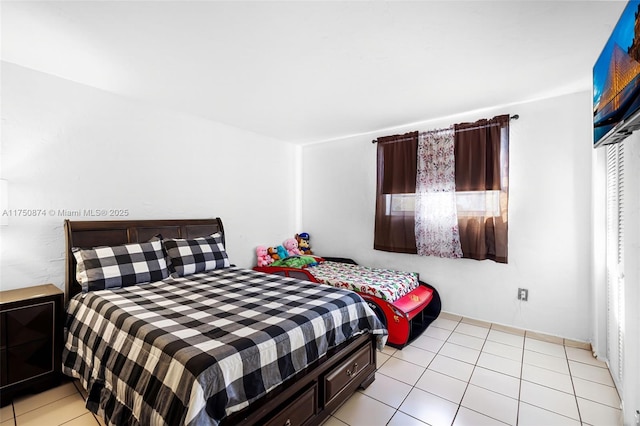 bedroom featuring light tile patterned flooring