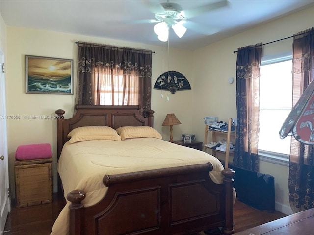 bedroom featuring ceiling fan and dark wood-type flooring