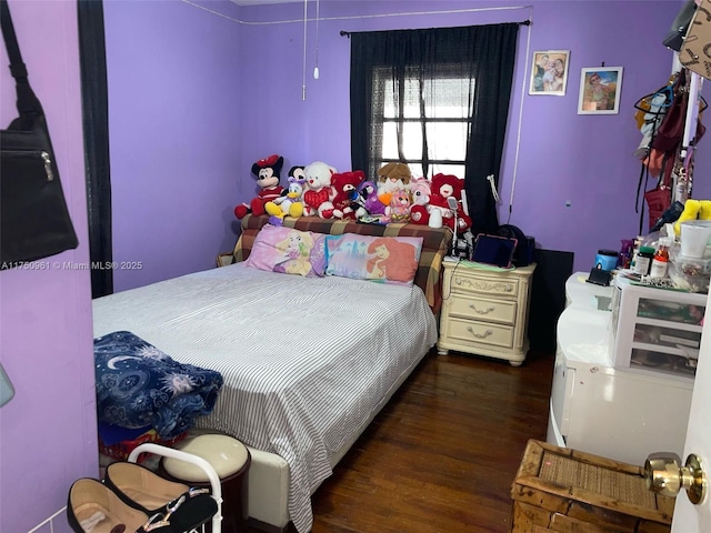 bedroom with dark wood-type flooring