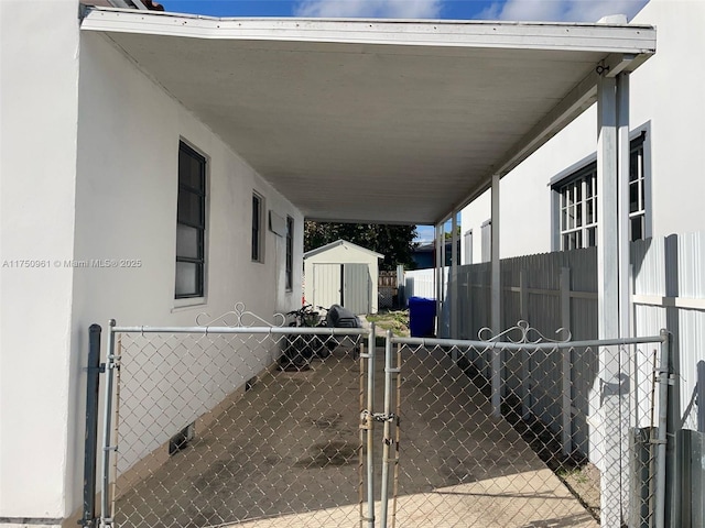 exterior space with a storage shed, an outdoor structure, and fence