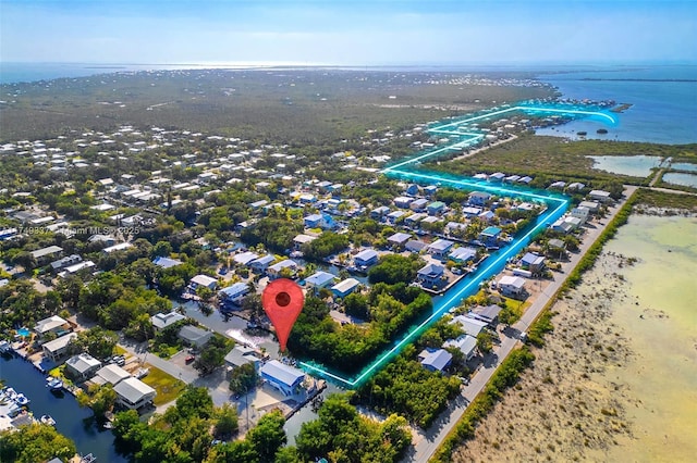 drone / aerial view featuring a water view and a residential view