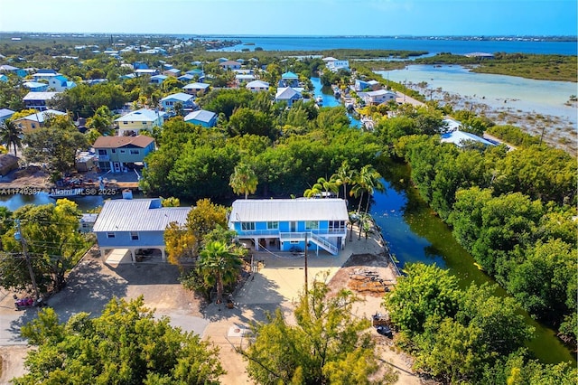 drone / aerial view featuring a water view and a residential view