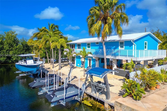 dock area with a water view and boat lift