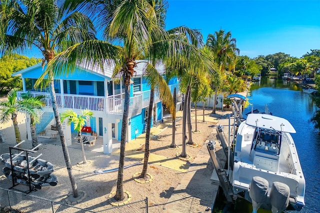 view of playground with a water view and fence