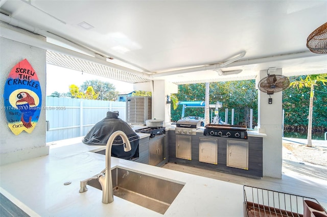 view of patio / terrace featuring exterior kitchen, a grill, and a sink