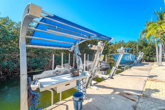 exterior space with a boat dock, a water view, and boat lift