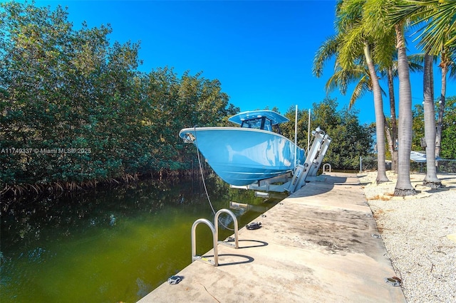 view of dock featuring a water view and boat lift