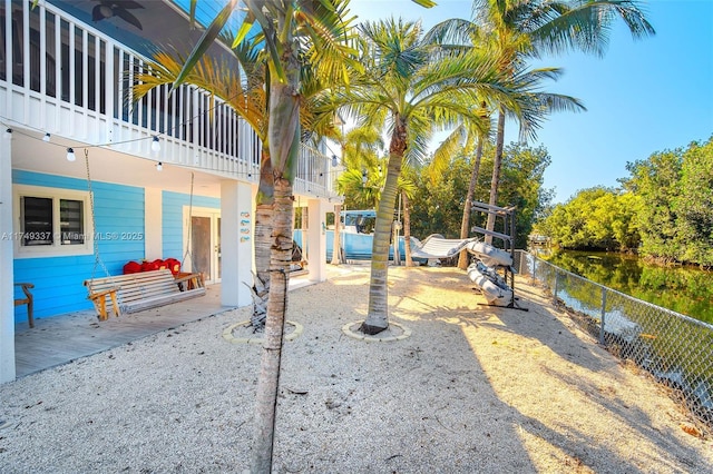 view of yard with ceiling fan, fence, and a patio