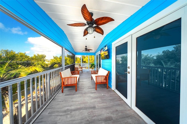 balcony with a ceiling fan and french doors